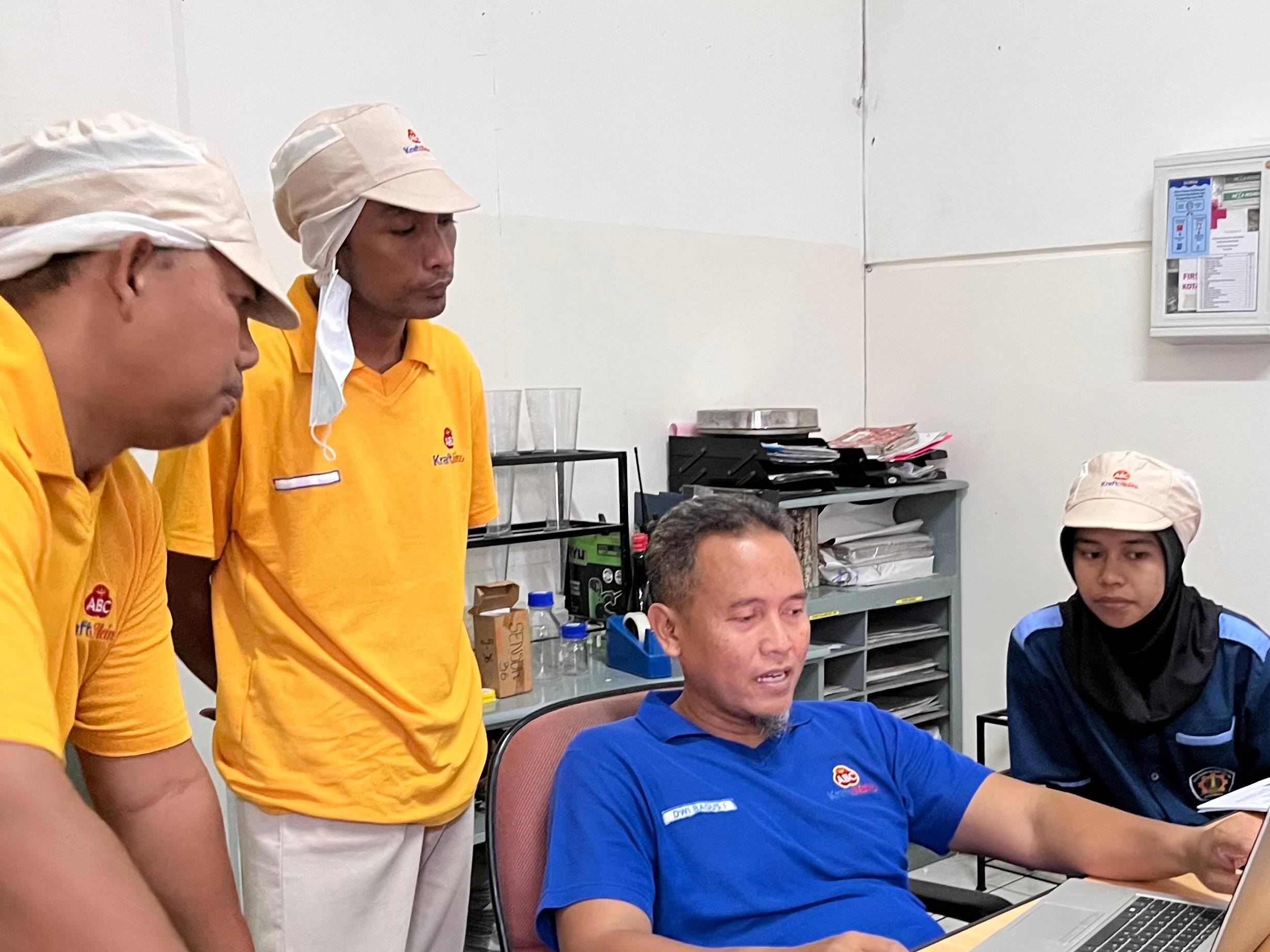 Work Instruction Training with Production Team Participating in a discussion and training session on work instructions with a Production Supervisor and team members at PT Heinz ABC Indonesia.