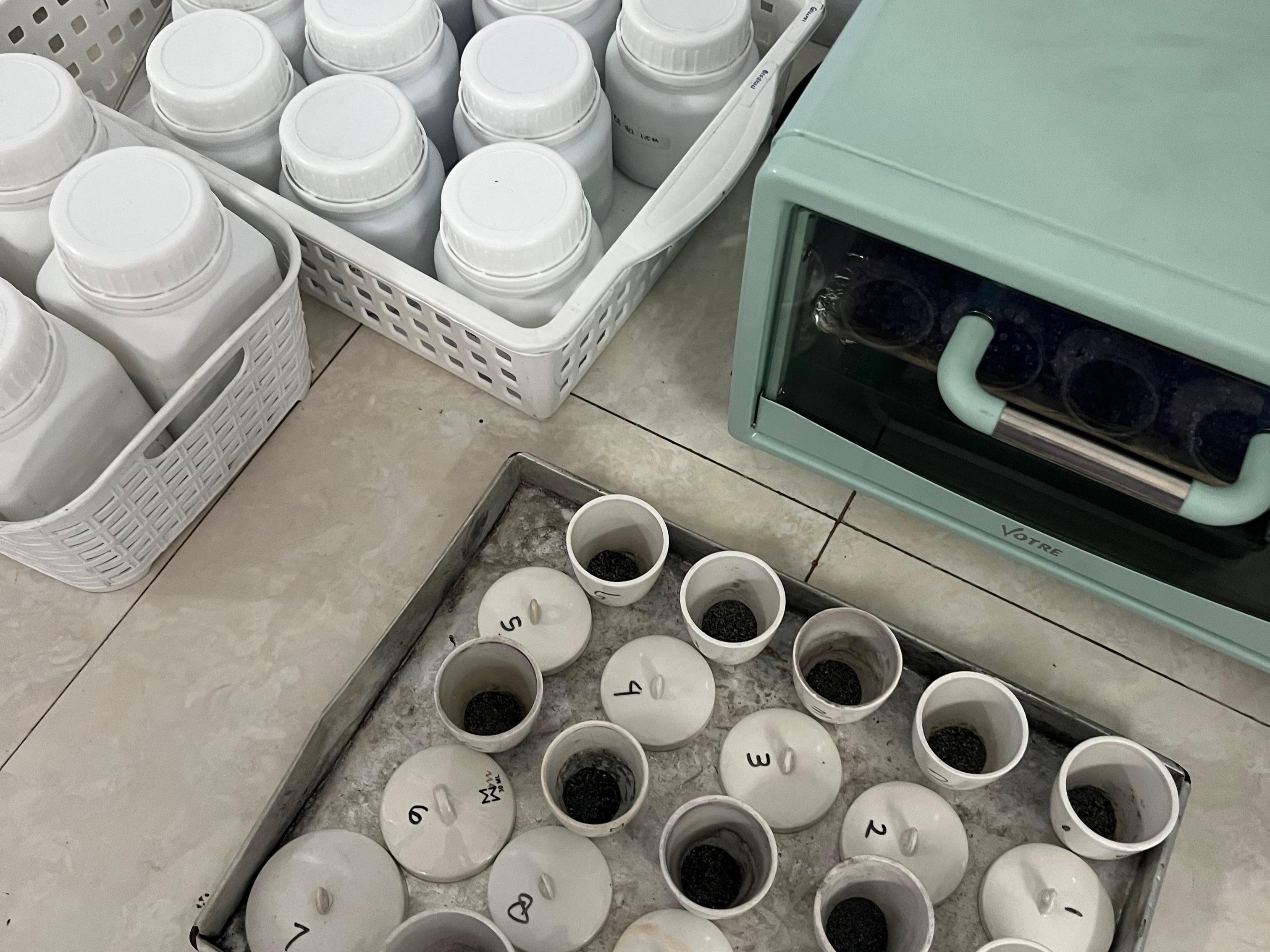 Prepared bottom ash samples arranged for treatment and preparation prior to adsorption experiments.